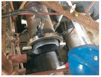 Portable split frame pipe cutter performing simultaneous cold cutting and beveling on an oil and gas refinery pipeline.