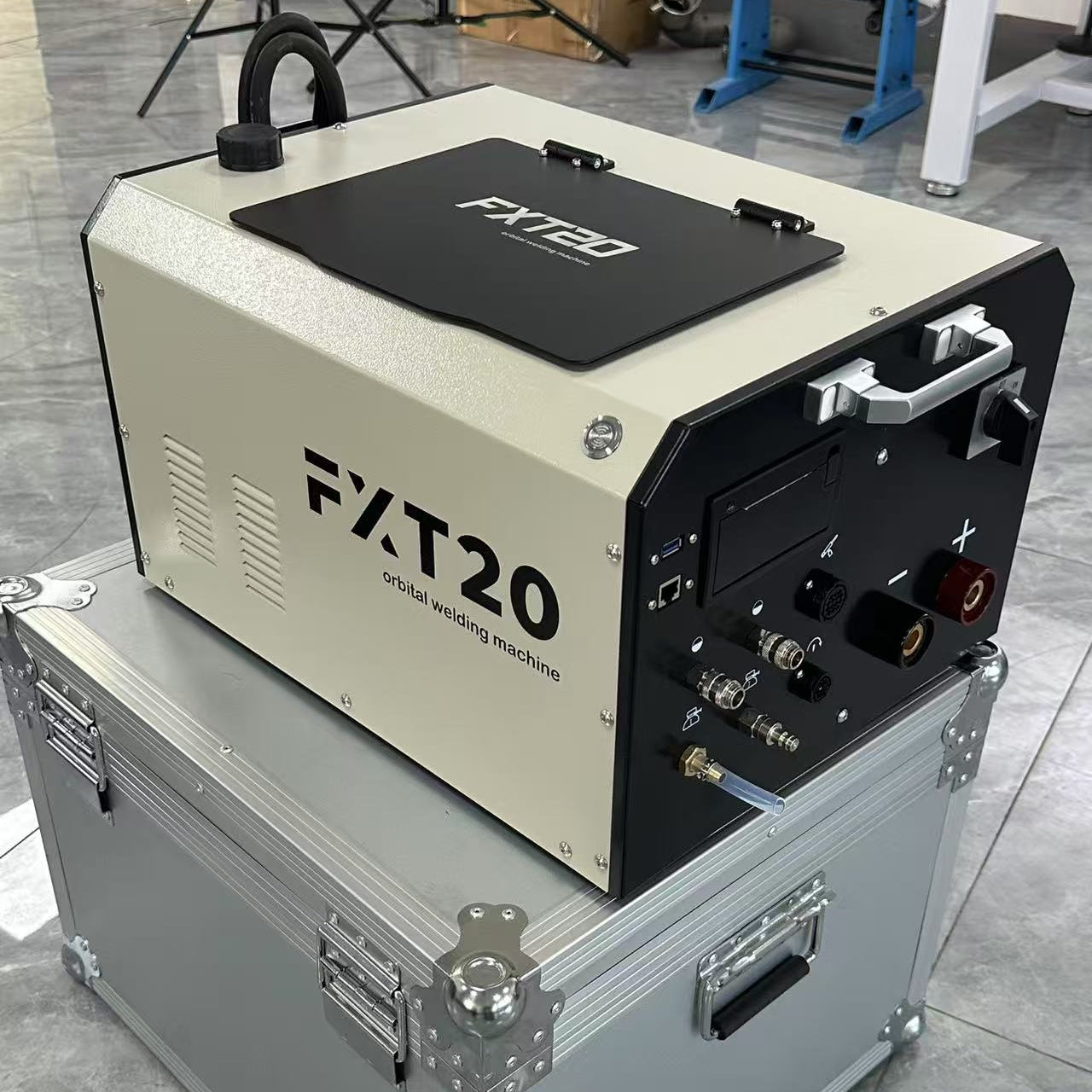 Portable FYID FXT20 digital orbital welder used in cleanroom gas cabinet installation, 33% more compact than traditional units